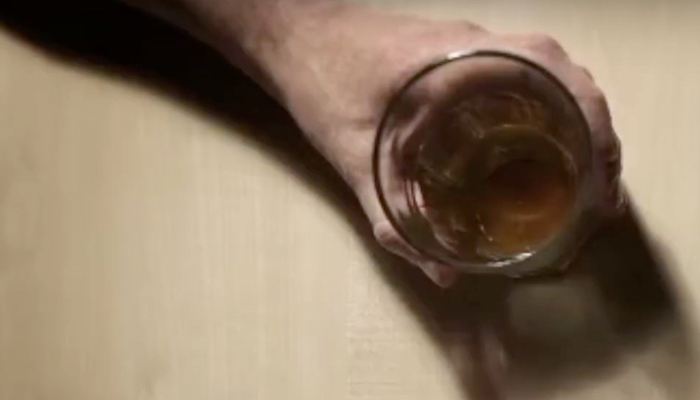A person holding an empty glass