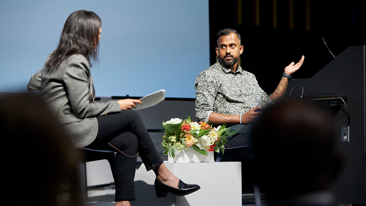 Nahlah Ayed and Robin Mazumder engage in a seated conversation on a stage.