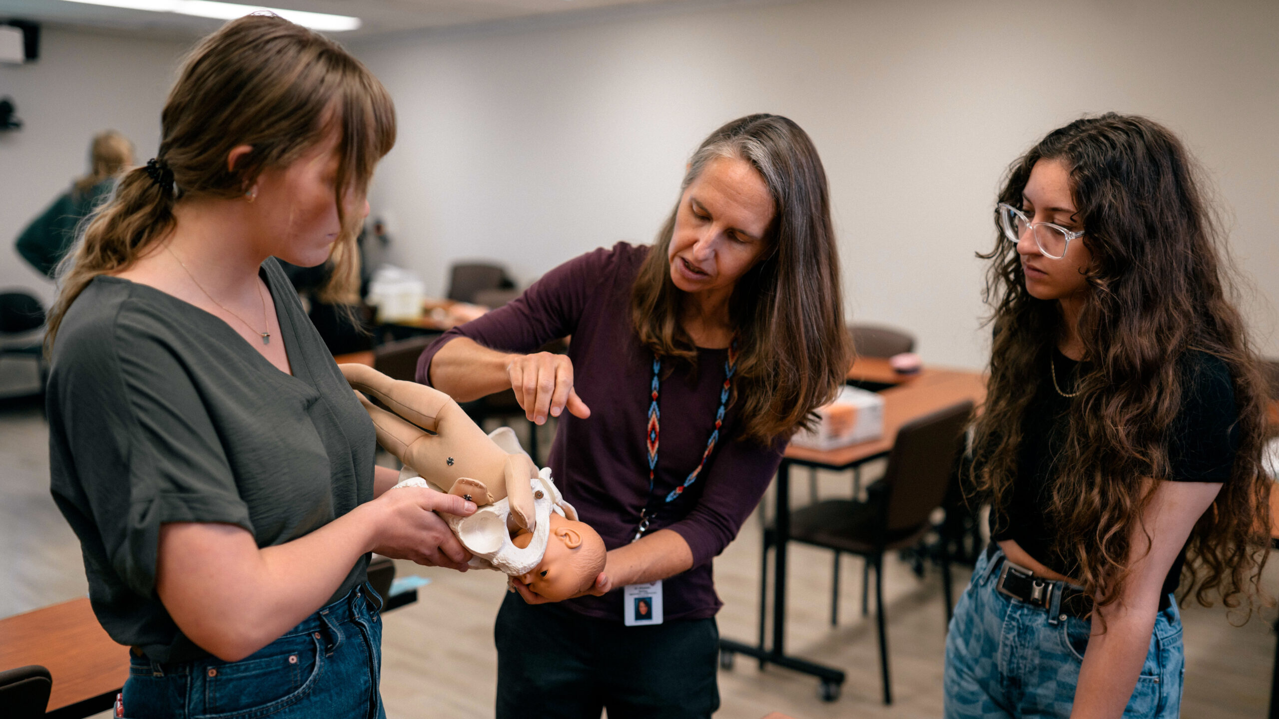 Liz Darling, director and assistant dean of midwifery at McMaster University, instructs students using a fetal doll.