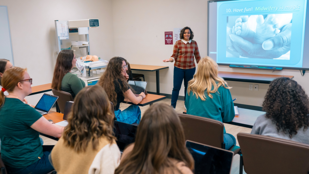 Claire Ramlogan-Salanga conducts a lesson in front of a class of students in McMaster University's midwifery program.