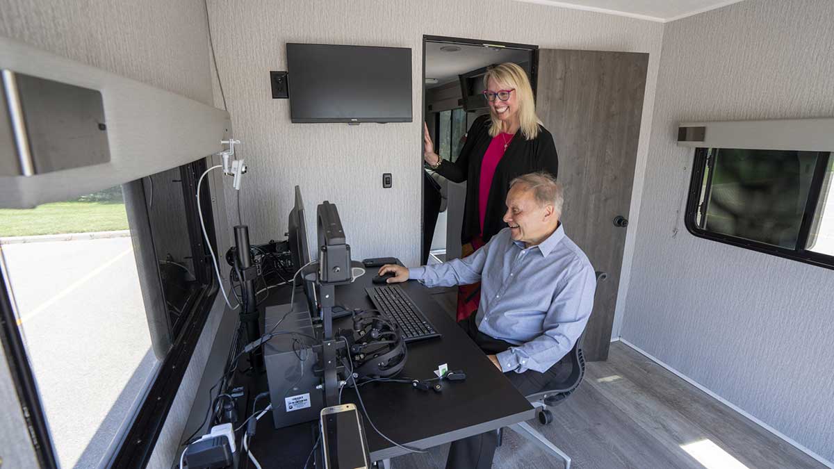 A participant uses the Mobile User Experience Lab (MUXL) vehicle