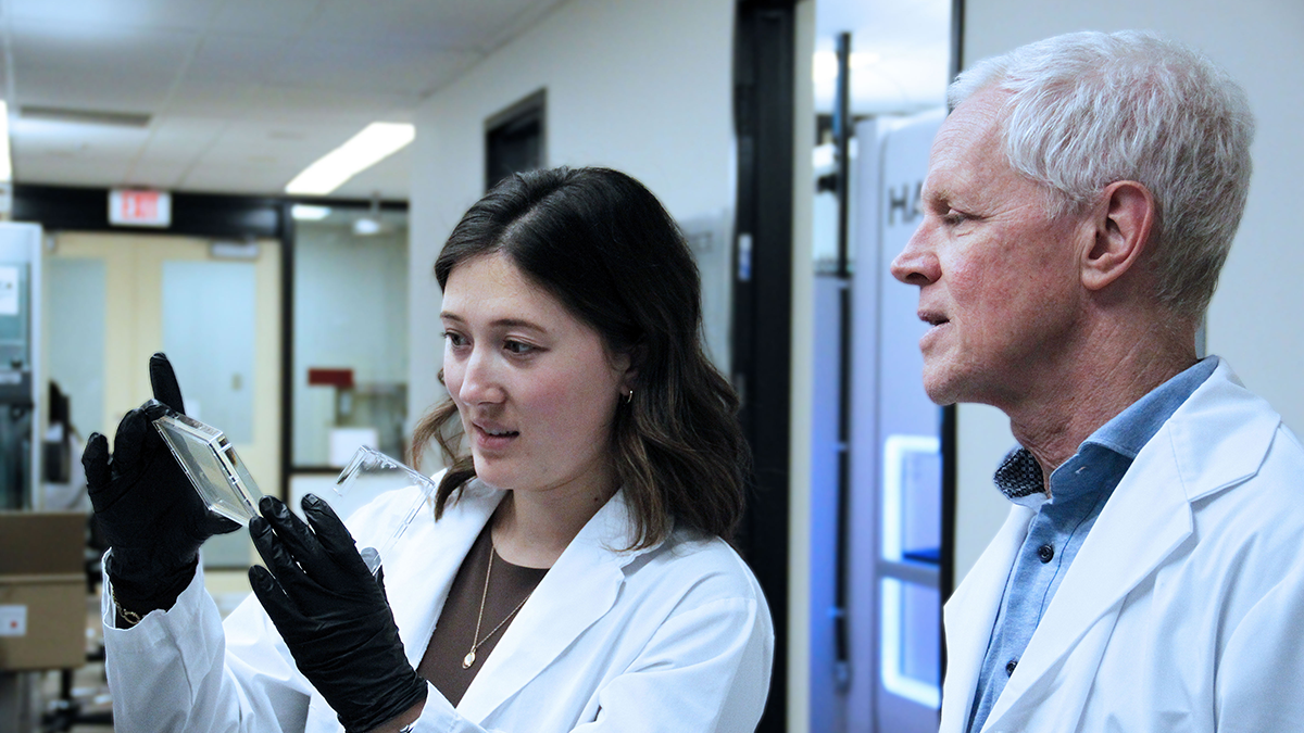 Megan Tu and Eric Brown examining bacterial specimens in a university lab.