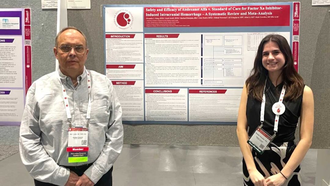 Mark Crowther and Rachael Principato stand in front of a research poster.